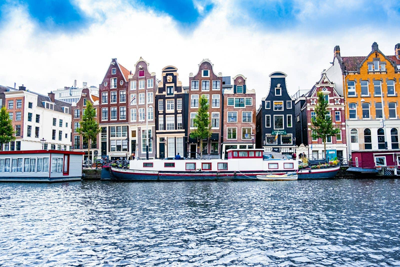 Colourful canal houses and houseboats on a bright day