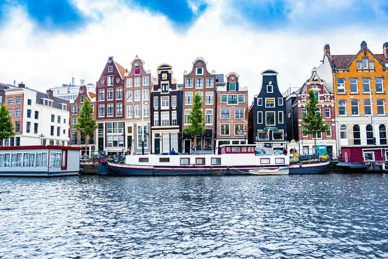 Colourful canal houses and houseboats on a bright day