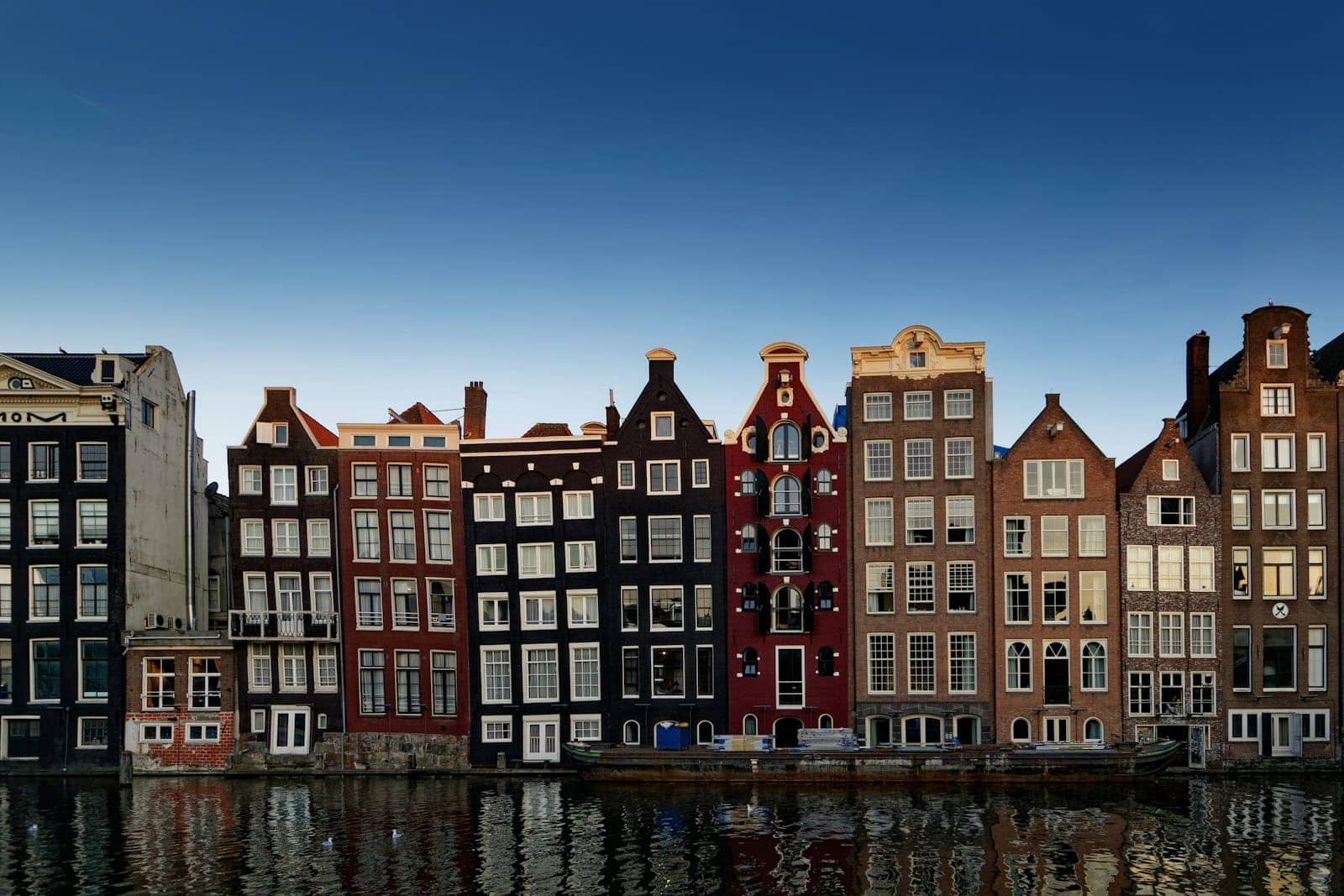 A row of brick canal houses in the evening light